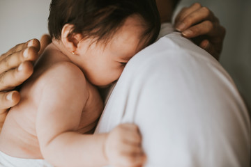 baby crying in her father's arms - closed plan - family