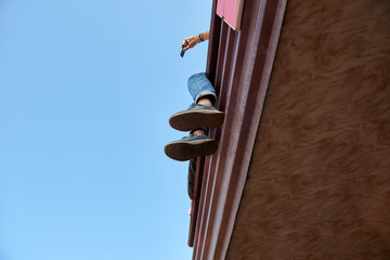 Feet of a young man sitting high