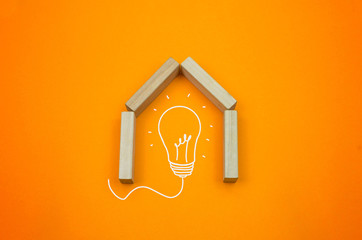 Creative house, home from toy blocks on the gradient, orange background idea creative concept bulb...