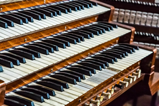 Close up of ancient pipe organ keyboards in european cathedral