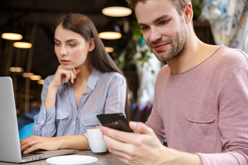 Attractive young couple having lunch at the cafe indoors