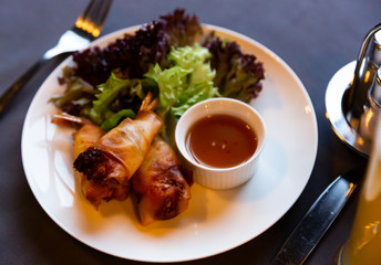 Fried spring rolls with vegetables and shrimps with sauce and salad