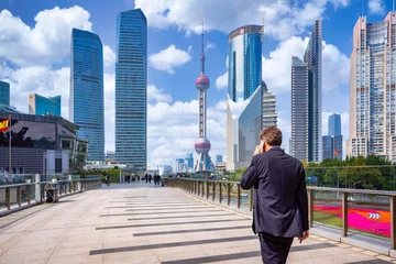 Rolgordijnen Shanghai Business man walking and use smartphone in shanghai city