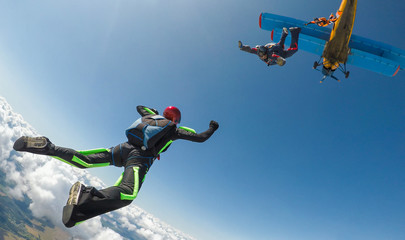 Skydivers jump out of the plane