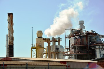 factory with smoke from chimneys