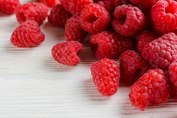 Bunch of fresh organic raspberry berries in neat pile, white background. Clean eating concept. Healthy nutritious vegan snack, tasty raw diet. Close up, copy space, top view, flat lay.