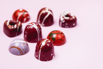 Luxury Bonbons Painted with Differents Colors on Pink background Beautiful and Exclusive Handmade chocolate Candy Horizontal