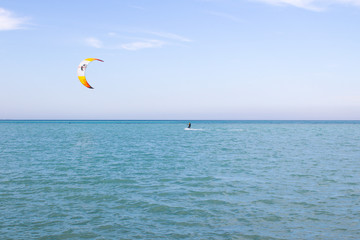 Kitesurfer rides on the sea. Kite surfing, kite boarding water sport, outdoor activities, hobbies...
