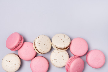 Pink and White Macarons on Blue Background French Dessert Caramel and Strawberry Macarons Horizontal Flat Lay Copy Space
