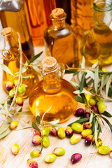 Olive oil in bottles on wooden table