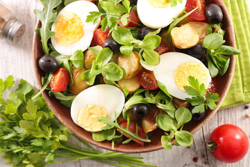 vegetable salad with boiled egg, olive, tomato and crouton