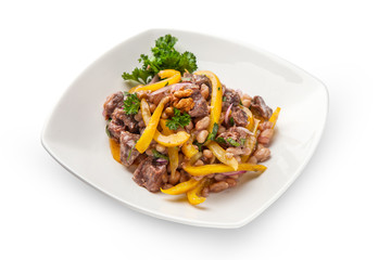 stew of white beans and bell yellow pepper with beef meat closeup with ingredients. On a white plate, isolated.