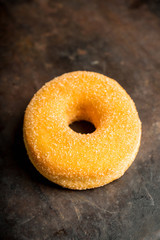 Donut with apple jam on the rustic background. Selective focus.