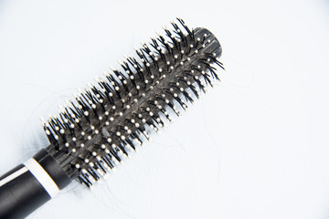 Comb with hair on white background.