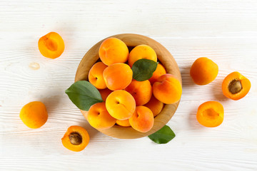 Bunch of fresh organic apricot fruits laid out on textured background. Clean eating concept....
