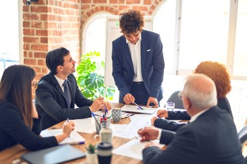 Group of business workers working together in a meeting. Listening one of them speaking at the office.
