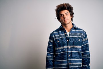 Fototapeta premium Young handsome man wearing casual shirt standing over isolated white background Relaxed with serious expression on face. Simple and natural looking at the camera.