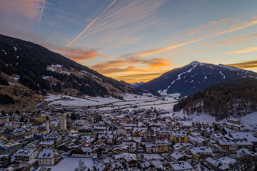 San Candido Innichen by night in South Tyrol Alto Adige, Italy during winter season. Aerial drone...