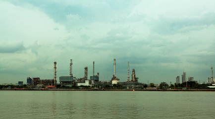 a standard and eco-friendly refinery, surrounded by rivers and sky, covered with clouds.