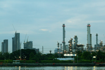 Fototapeta na wymiar Oil refinery environmentally friendly, with sky and clouds, river
