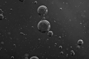 Dark background. Liquid with air bubbles for projects, oil, honey, beer, juice, shampoos. Black and...