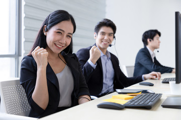 Group of call center staff talking and provide services to customers via headphones and microphone cable. Professionals with speech, memory and information recording skills.