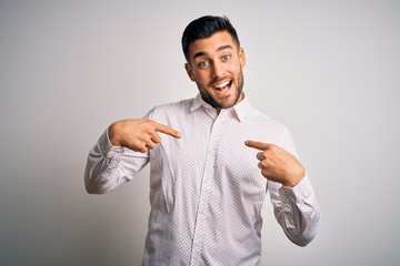 Young handsome man wearing elegant shirt standing over isolated white background looking confident...