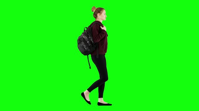 Happy Girl Walking With a Backpack in Casual Hoodie and Black Jeans Green Screen