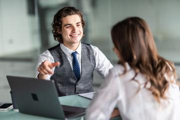 Young pretty business woman and handsome man have meeting in the office