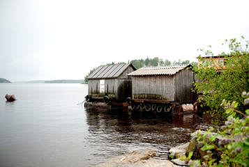 wooden boat sheds in the water on the lake. Russia, Onega Lake