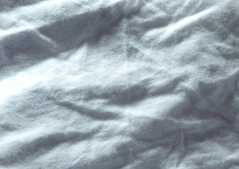 A textile set of crumpled white fabric with pleats and waves.