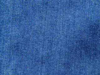 Fototapeta na wymiar Denim close-up as an abstract textile background for the design. Blue jeans.