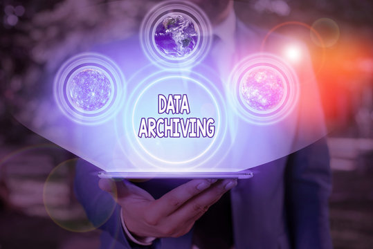Conceptual hand writing showing Data Archiving. Concept meaning to secure and to store data for long term retention Elements of this image furnished by NASA