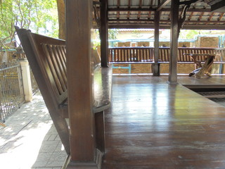 Fototapeta premium A wooden table and chair in a temple pavilion