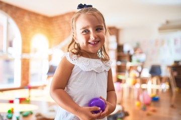 Young beautiful blonde girl kid enjoying play school with toys at kindergarten, smiling happy playing at home