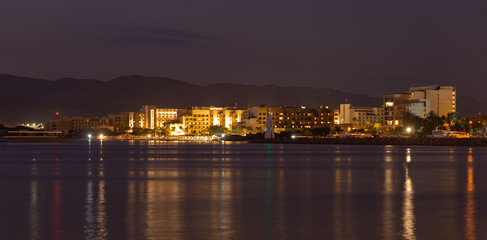 Sunset in Aqaba city, view of Eilat city in Israel. Aqaba city, Jordan