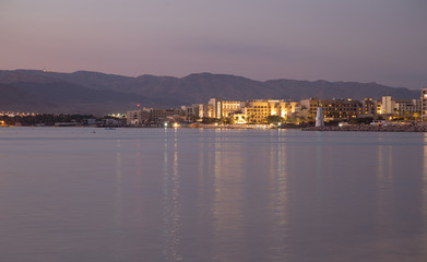 Naklejka na ściany i meble Sunset in Aqaba city, view of Eilat city in Israel. Aqaba city, Jordan
