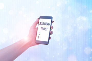 Writing note showing Building Trust. Business concept for activity of emerging trust between...