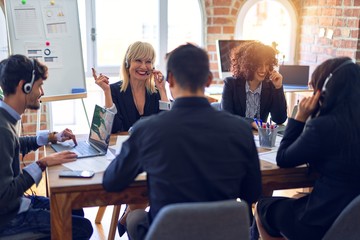 Group of call center workers smiling happy and confident. Working together with smile on face using headset at the office.