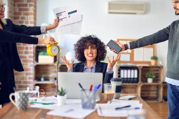 Group of business workers working together. Partners stressing one of them at the office