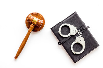 Arrest concept. Handcuffs near judge gavel on white background top-down