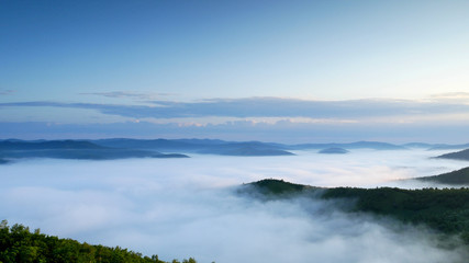 Beautiful cloud sea among mountains in the morning; white fog on the top of mountains