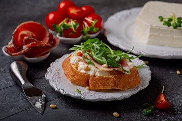 Bruschetta with Italian  cheese of cow's-milk and prosciutto