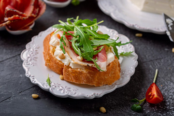 Sandwich with Italian  cheese Stracchino , arugula, prosciutto and pine nuts