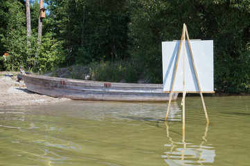 The easel with canvas in the water of a river