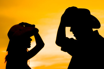 a happy cowboy couple silhouette background