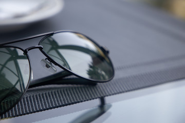 A reflective sunglasses lying on a table
