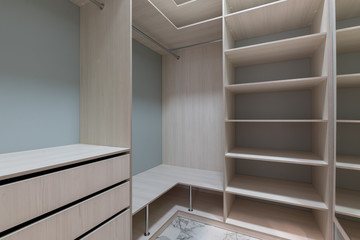 empty dressing room with wooden light furniture.
