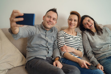 Group of friends taking picture of themselves. Cheerful friends taking selfie