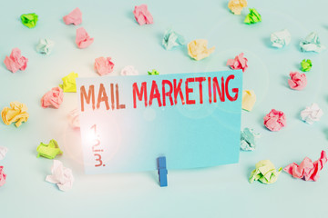 Writing note showing Mail Marketing. Business concept for act of sending a commercial message to a group of showing Colored crumpled papers empty reminder blue floor background clothespin